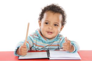 little boy practicing his writing skills