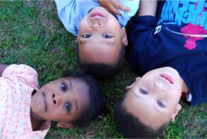 children laying on the grass