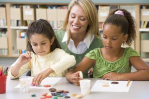 children doing arts with their teacher